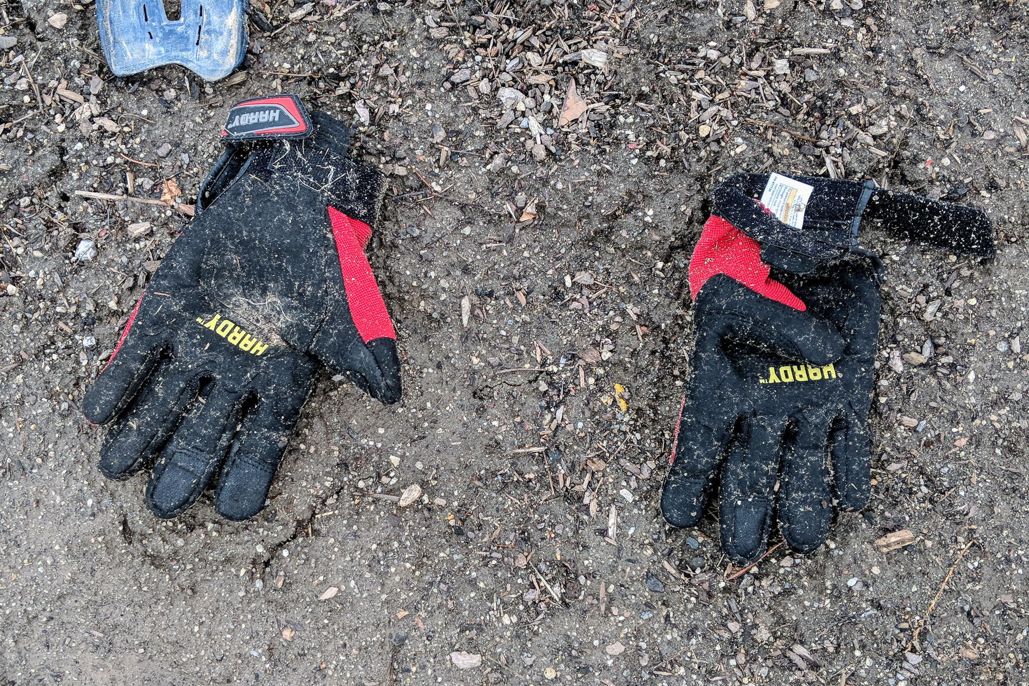 Dirty pair of work gloves on the ground